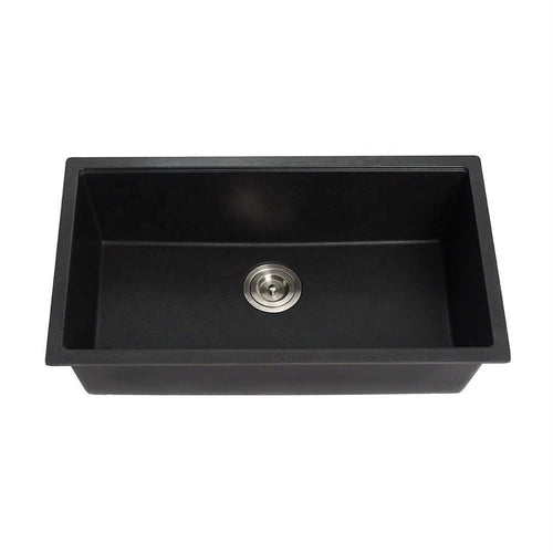 Black kitchen sink with silver drain on a white background